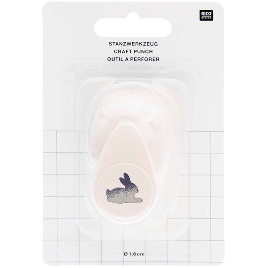 Ausgestanzte Hasen-Motive aus weißem Bastelpapier als DIY-Tischstreu für die Kinderbeschäftigung