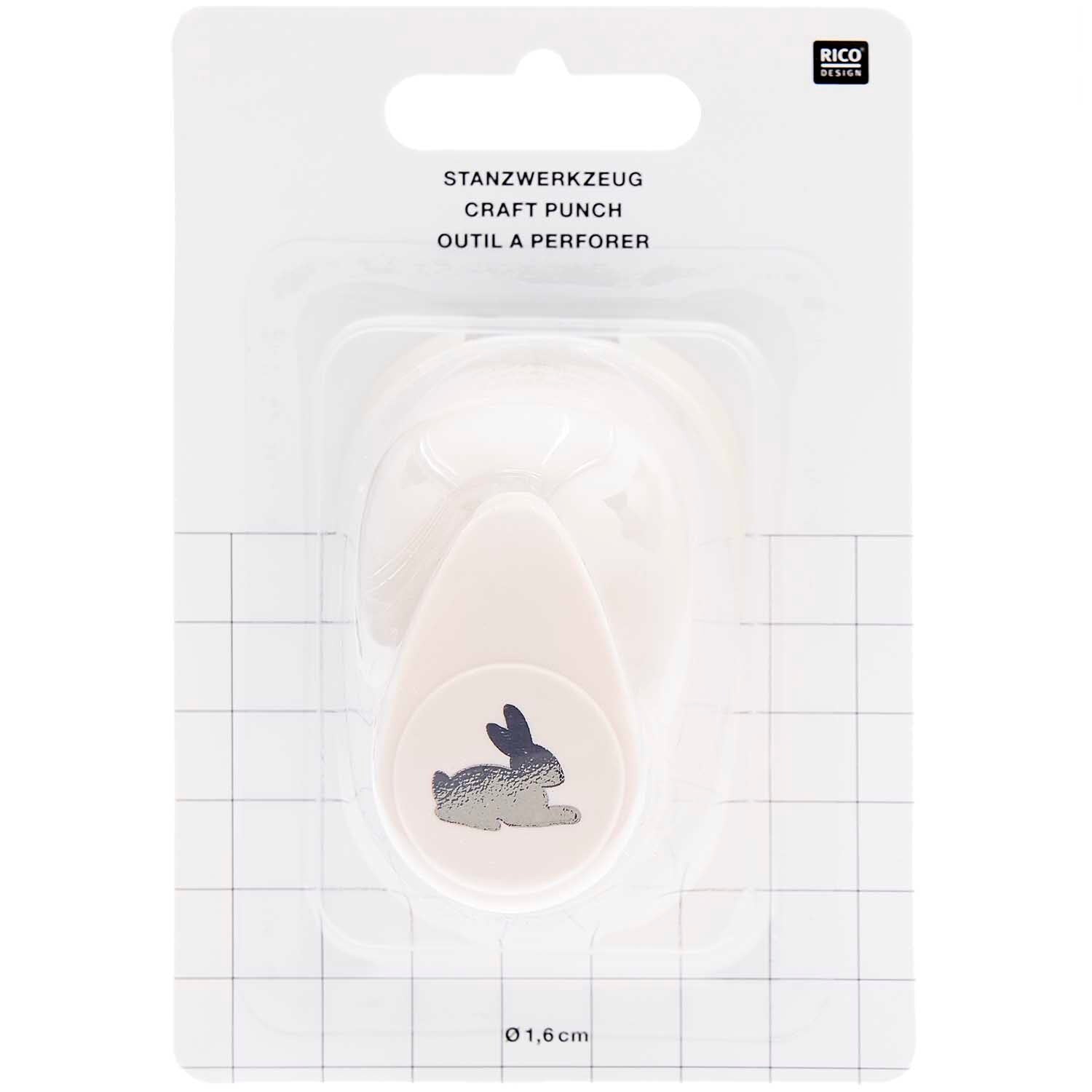 Ausgestanzte Hasen-Motive aus weißem Bastelpapier als DIY-Tischstreu für die  Kinderbeschäftigung