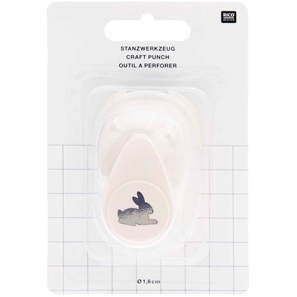 Ausgestanzte Hasen-Motive aus weißem Bastelpapier als DIY-Tischstreu für die  Kinderbeschäftigung